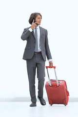 successful businessman with Luggage talking on the phone.