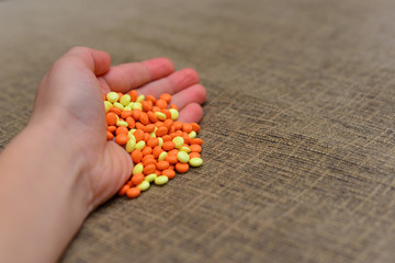 Different colored medications and tablets on a wooden texture table