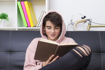 adolescent or preteen student with the textbook at home