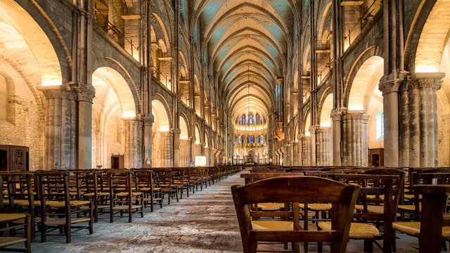 Warm illumination main hall interior of Saint Remi abbey in Reims, France