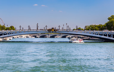 Fototapeta na wymiar The Alexander III Bridge across the Seine in Paris, France. View from the water