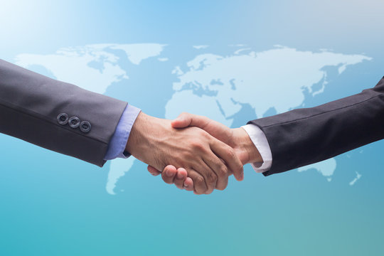 close up business man hand shake together for agreement on world map background , ceo meeting concept