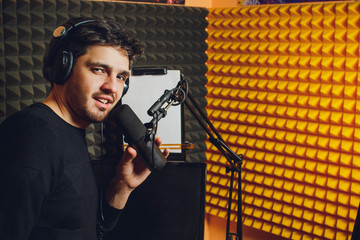 Microphone in radio studio and presenter on background