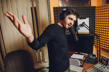 Microphone in radio studio and presenter on background