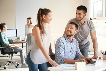 Group of young professionals having meeting in office