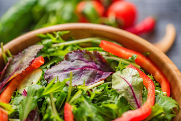 Fresh rustic vegetable salad on rustic background