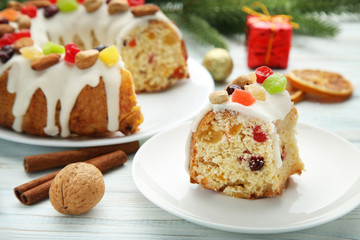 Slice of bundt cake with walnut and cinnamon on wooden table