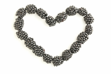 Blackberries in heart shape isolated on white background