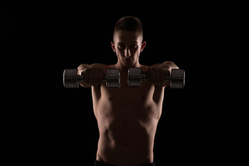Fototapeta na wymiar Young athlete exercise with weights