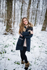 Beautiful brunette girl in winter warm clothing. Model on winter jacket.