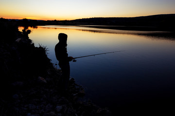 Fototapeta na wymiar fishing at sunset near the sea.