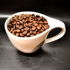 Coffee Beans In Cup On Black Background Close Up Isolated