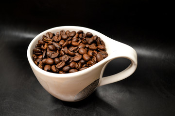 Coffee Beans In Cup On Black Background Close Up Isolated