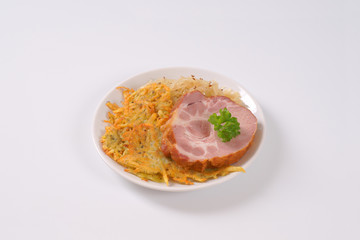 smoked pork with potato pancakes and sauerkraut
