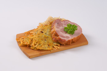 smoked pork with potato pancakes and sauerkraut