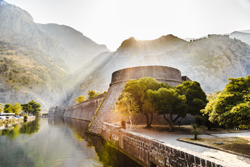 a picturesque mountain landscape, the fortress of the old town of Kotor at dawn, Montenegro - obrazy, fototapety, plakaty