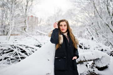 Beautiful brunette girl in winter warm clothing. Model on winter jacket.