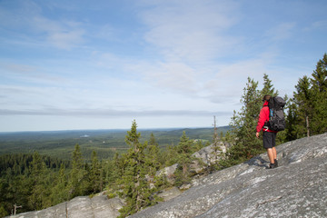 Fototapeta na wymiar Hiker standing on the summit Akka-Koli and enjoys the natural landscape, summer 