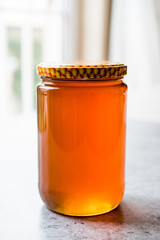 Honey in Jar with Lid. Copy Space.