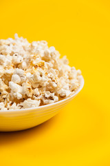 Pop corn in a vase on yellow background. Minimalist