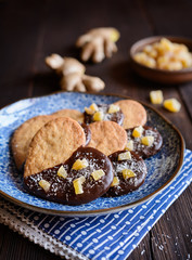 Ginger biscuits decorated with chocolate and pieces of candied ginger