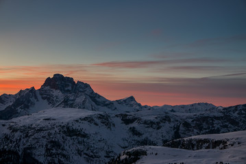 Aerial view of vivid beautiful sunset over winter alpine landscape