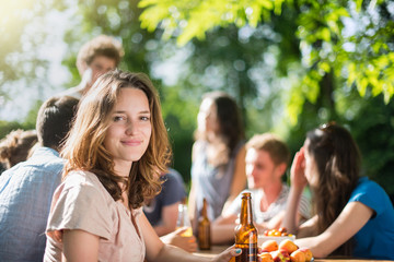 Group of young people having fun outside, focus on a young woman
