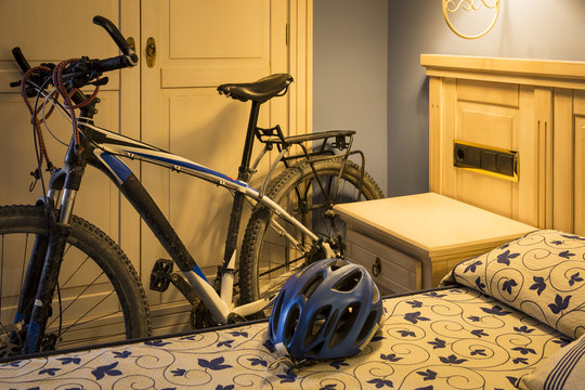 a mountain bicycle and a helmet in a hotel room - Bicycle touring