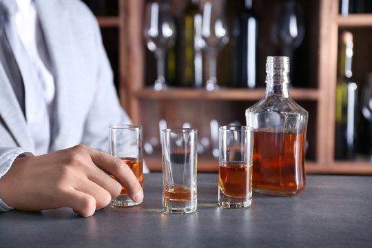 Man drinking whiskey in bar. Alcohol dependence concept