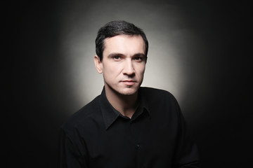 Attractive young man on black background