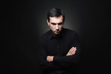 Attractive young man on black background