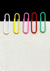 note paper with paperclip on a black background. copy space