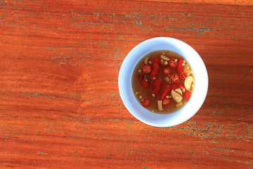 chili sauce over wooden background