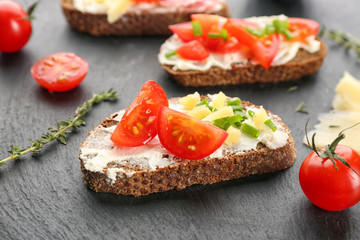 Tasty bruschetta with cherry tomato on table, closeup