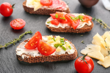 Tasty bruschetta with cherry tomato on table, closeup