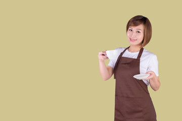 Coffee serving waitress. Young asian barista woman smiling showing cup of coffee. Isolated on solid color background. 