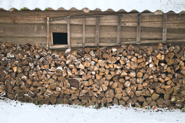 firewood stacked up against the old walls