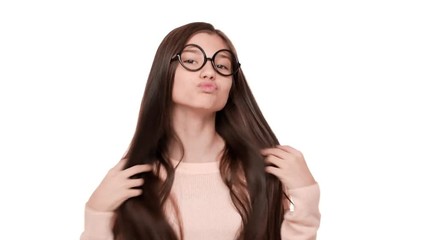 Portrait of young funny woman admiring herself wearing trendy glasses fooling around making flirty face over white background in studio. Concept of emotions