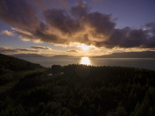 Sunset Over Orcas Island, Washington.  Aerial view of the sun setting over one of the San Juan Islands in the Puget Sound archipelago of Washington State.