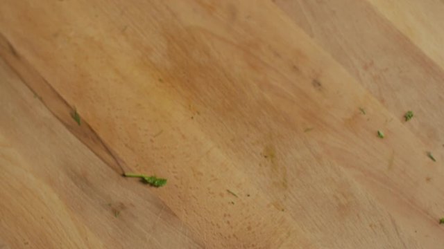 Dill & french parsley falling on a wooden plunk