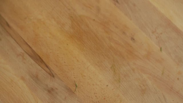 Dill & french parsley falling on a wooden plunk