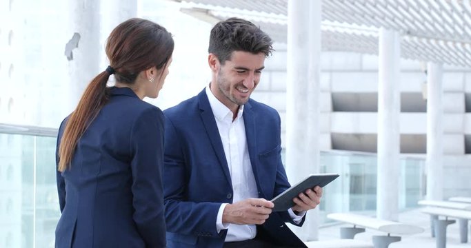 Business people using tablet together