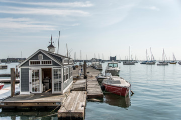 Rows of sailing boats and luxury yachts anchored in Boston harbor pier Names and trademark are...