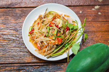 Thai food Papaya salad Spicy flavor On the old wood table