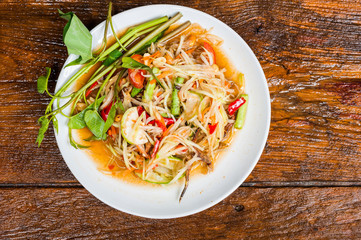 Thai food Papaya salad Spicy flavor On the old wood table