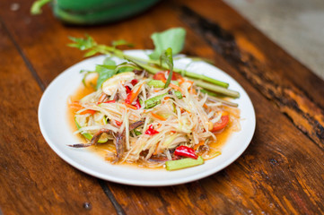 Thai food Papaya salad Spicy flavor On the old wood table