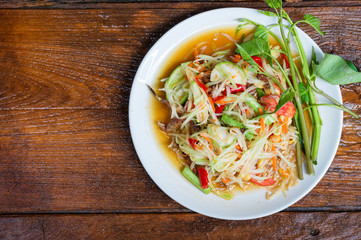 Thai food Papaya salad Spicy flavor On the old wood table