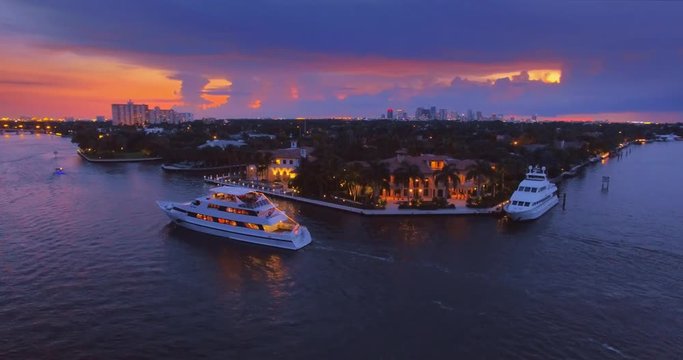 Miami cityscape at sunset, yachts, boats commuting on river 4K UHD aerial view