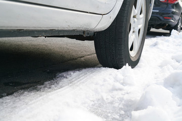 Low angle view on vehicle tire on snow in the street