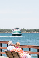 Fototapeta premium Lake Erie Ferry Couple Sitting on Bench, room for copy